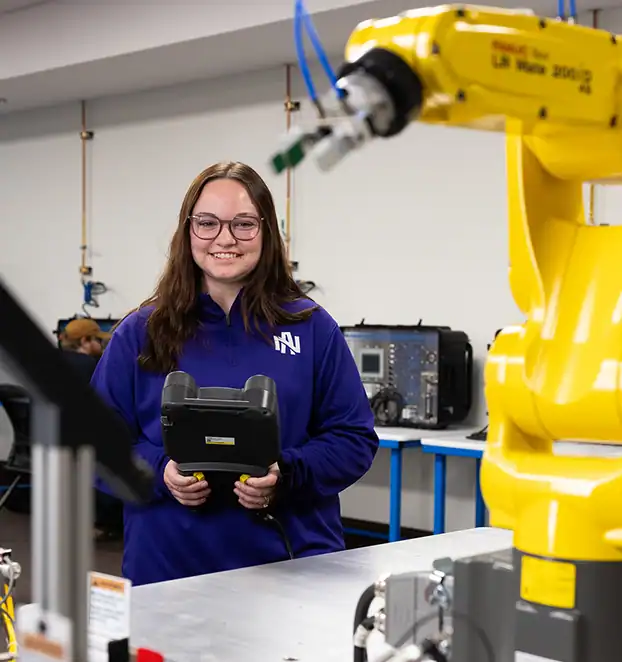 Robotic arm operating in UNA engineering lab environment.